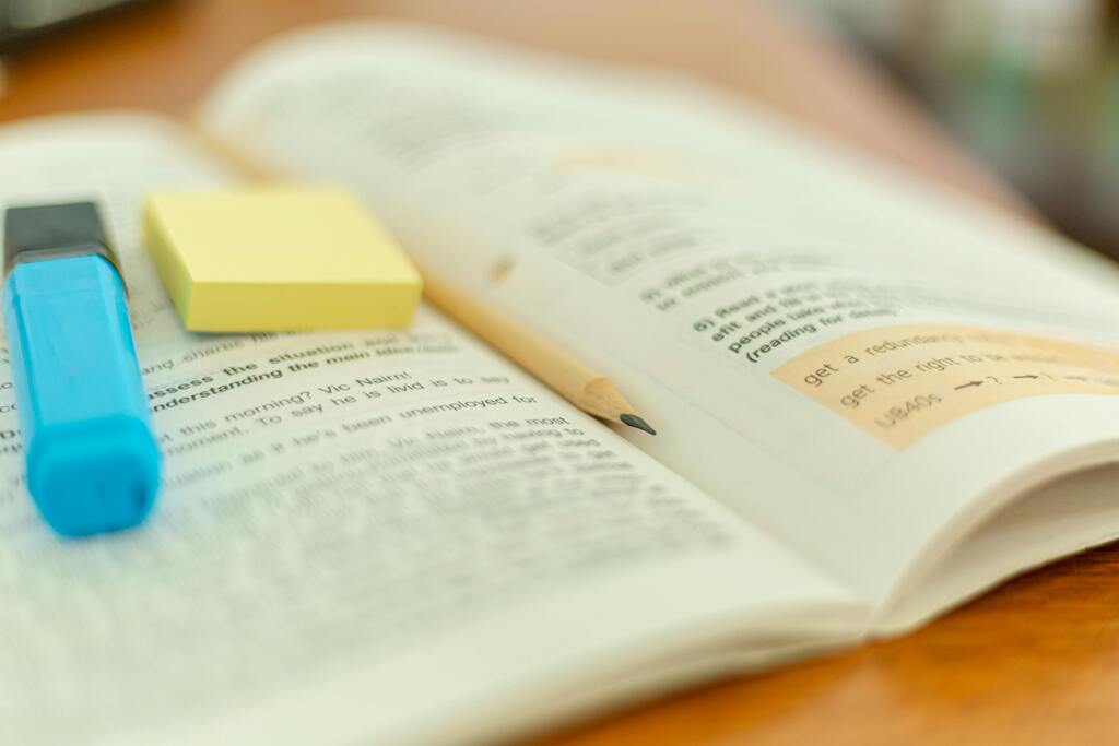 Stock image of textbook with note taking implements.